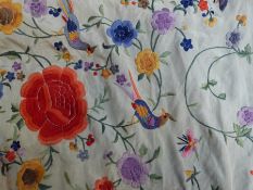 An embroidered shawl with floral decoration with birds of paradise