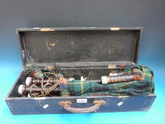 A cased set of late 19th to early 20th century bagpipes in thought to be African hardwood with