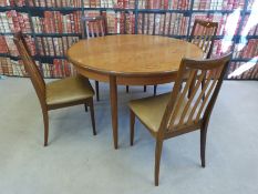 A G-Plan extending dining table and four chairs