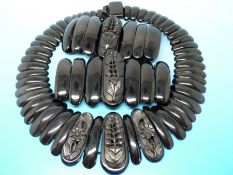 A set of Victorian/ Edwardian jet mourning jewellery to include two cuffs each with a central