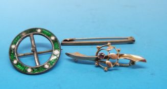 A Charles Horner silver brooch decorated with green enamel together with two yellow metal brooches