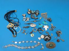 A large silver bow brooch, filigree brooch, leaf brooch, butterfly wing brooch, other brooches,