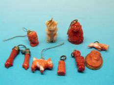 A quantity of coral charms to include a dog, cameo,