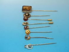 Eight stick pins to include a 15ct example set with a diamond,