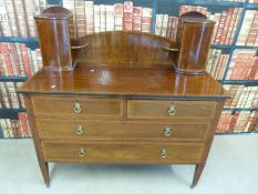 An inlaid mahogany dressing chest with two turret cupboards above (W21.