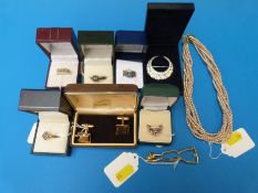 Four silver rings set with various stones together with two others, a brooch, bracelet,