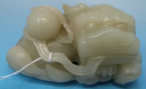 A Chinese carved celadon jade figure of a recumbent lion and cub with brocade ball atop (8.