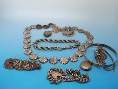 A white metal necklace, silver brooches, white metal bracelets,