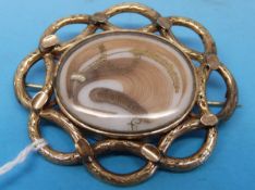 A yellow metal mourning brooch with a lock of hair to front and braided hair to the back