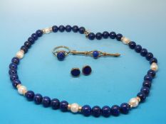 A suite of 9ct gold and lapis lazuli jewellery to include a ring, earrings,