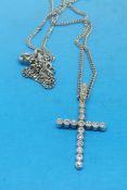 An 18ct white gold pendant in the form of a cross set with diamonds on an 18ct white gold chain