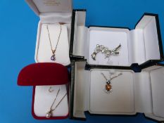 Two 10K gold pendants and chains, one set with an amethyst and one a pearl,