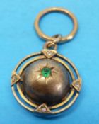 A Victorian gold pendant set with an emerald to the centre and diamonds to the outer edge with
