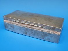 A hallmarked silver cigarette box of oblong form,