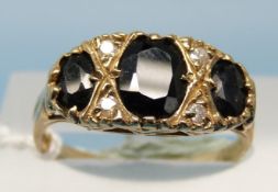 A 9ct gold ring set with three large oval sapphires with alternating diamonds (size N)