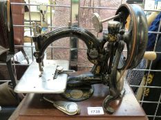 A wooden-cased Willcox & Gibbs sewing machine and accessories,