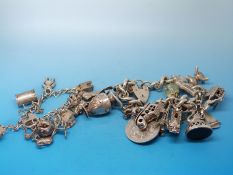 Two silver charm bracelets with a large quantity of silver/ white metal charms