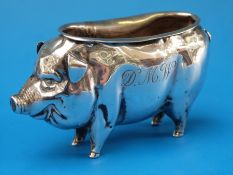 A silver pin cushion in the form of a pig
