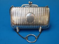A white metal purse on chain with engraved decoration,