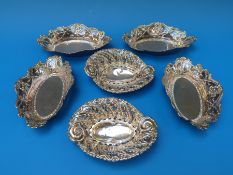 A set of four embossed hallmarked silver bon bon dishes, Birmingham 1904,
