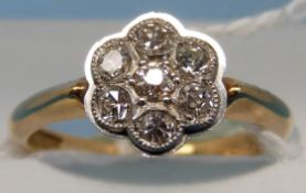 An 18ct gold ring set with seven diamonds in a flower cluster (size J)