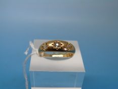 A hallmarked 18ct gold ring set with three diamonds in a star setting (size O)