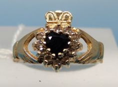 A 9ct gold ring set with a sapphire and diamonds in a heart shape (size M)