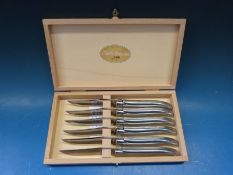 A wooden cased set of Claude Dozorme knives
