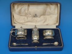 A cased hallmarked silver Mappin and Webb three piece cruet set,