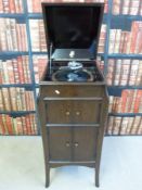 An Apollo wind-up gramophone with cabinet under