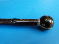 A walking cane with spherical tigers eye top