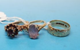 Three 9ct gold rings, one set with a quartz, one a plain band and one with red stones (7.