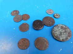 A small collection of Roman coins including a silver example