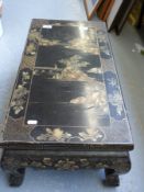 A Chinese lacquered low table with gilt chinoiserie landscape decoration
