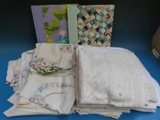 A quantity of linen and lace and two needlework books