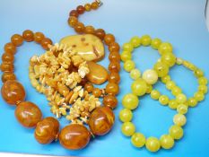 An amber necklace consisting of over 100 irregularly shaped pieces (26g) together with two amber