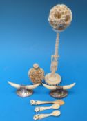 An ivory puzzle ball on stand, together with a pair of ivory-mounted knife rests,