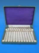 A cased set of white metal forks, six of one oriental design stamped sterling 900,
