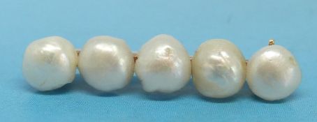A 14ct gold bar brooch set with five natural pearls