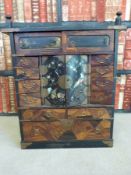 A 19thC Japanese specimen wood and lacquer multi drawer cabinet.