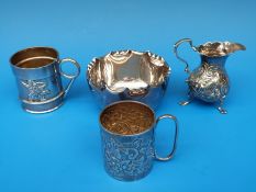 A Georgian hallmarked silver jug raised on three feet together with two hallmarked silver