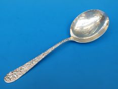 A Jacobi & Jenkins white metal serving spoon with floral and scrolling decoration to handle marked