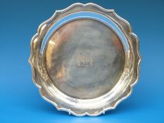 A hallmarked silver platter, with the letter T 1888, 1913 and CW formed as a logo to the centre,