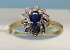 An 18ct gold ring set with a central sapphire surrounded by diamonds (size L)