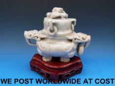 A Chinese pale greyish-green jadeite tripod censer carved with dragon head ring handles and coiled