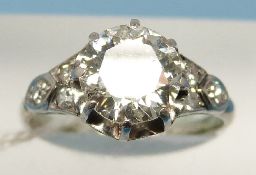 A platinum and 18ct gold ring set with a round brilliant cut solitaire diamond measuring