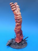 A large coral specimen mounted on a relief moulded metal base,