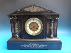 A Victorian slate French mantel clock in Romanesque style case with marbled decoration,