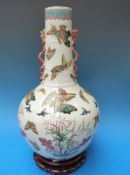 A 19thC Chinese bottle vase with famille verte bird, butterfly and floral decoration,