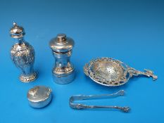 A German white metal tea strainer with eagle atop a column,